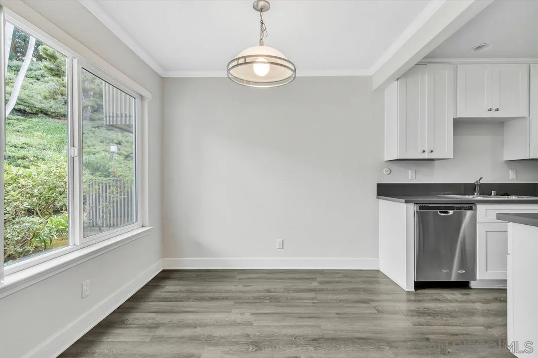 8541 Villa La Jolla Drive, Unit E La Jolla, CA 92037 - Photo 11 of 25 an empty room with wooden floor and windows