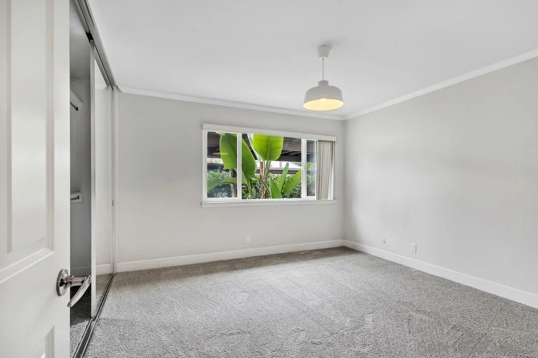 8541 Villa La Jolla Drive, Unit E La Jolla, CA 92037 - Photo 13 of 25 an empty room with windows and entrance