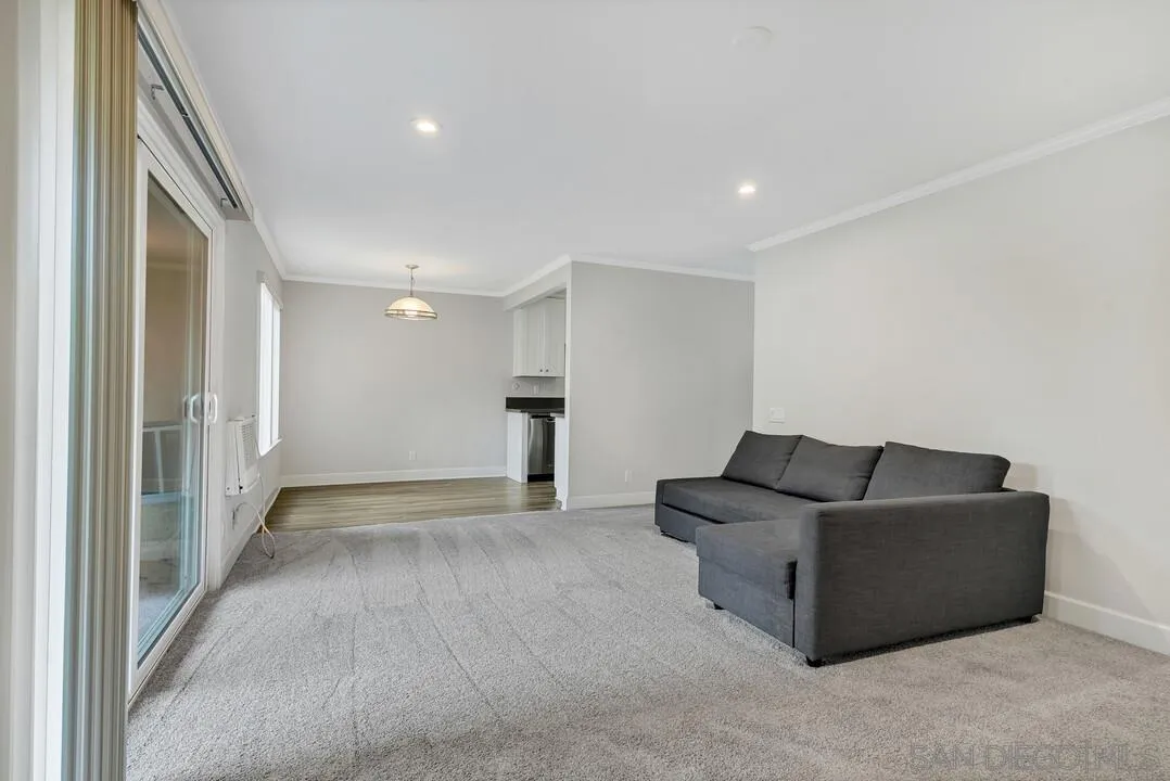 8541 Villa La Jolla Drive, Unit E La Jolla, CA 92037 - Photo 10 of 25 a living room with furniture and a walk in closet