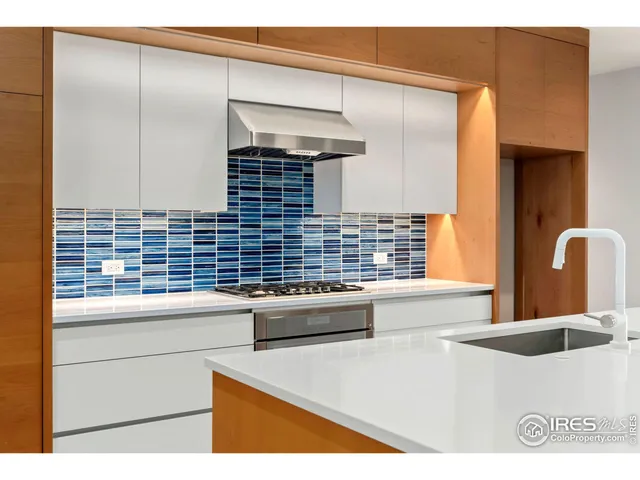 a kitchen with a sink cabinets and a large window