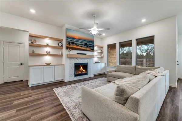 a living room with furniture a fireplace and a flat screen tv