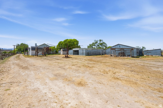 3732 Campbell Road Tooele, UT 84074 - Photo 60 of 69 Expansive rural property featuring multiple outbuildings, a gravel driveway, and mature landscaping