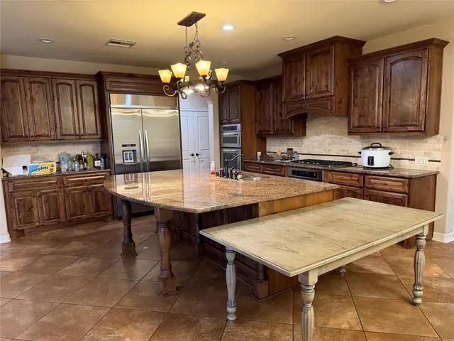 a kitchen with a table and chairs in it