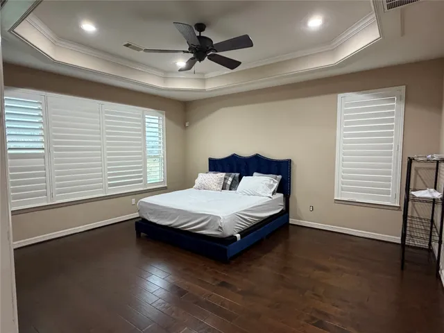 a spacious bedroom with a bed and a large window
