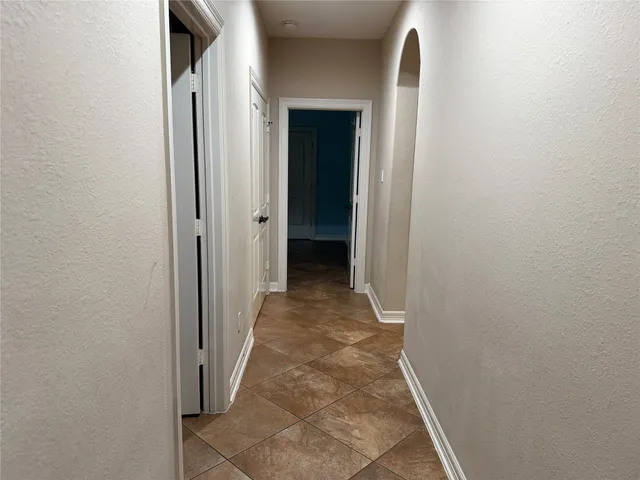 a view of a hallway with wooden floor and closet