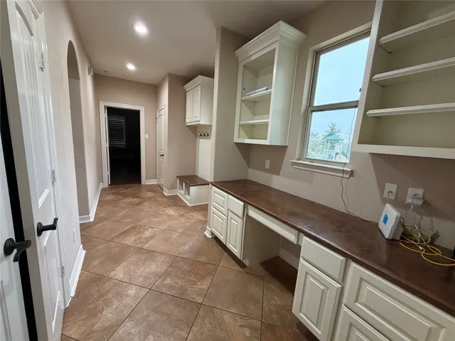 a spacious bathroom with a granite countertop sink a mirror and a bathtub