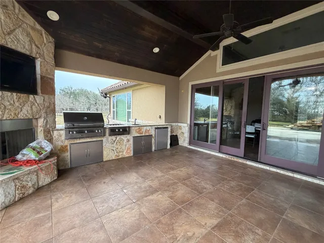 a open kitchen that has a lot of cabinets and refrigerator