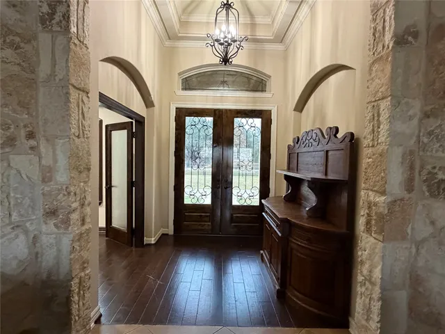 a view of a entryway door with hallway and a kitchen