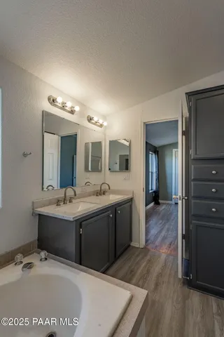 a large bathroom with a sink and mirror