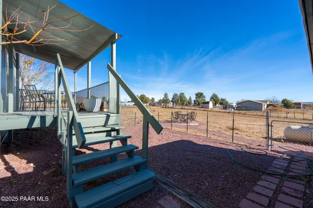 a view of a balcony with wooden floor and fence