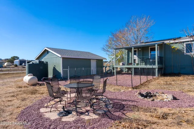 a view of a house with backyard and sitting area