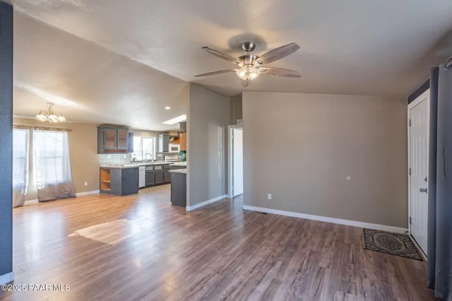 a view of a kitchen with wooden floor and a kitchen