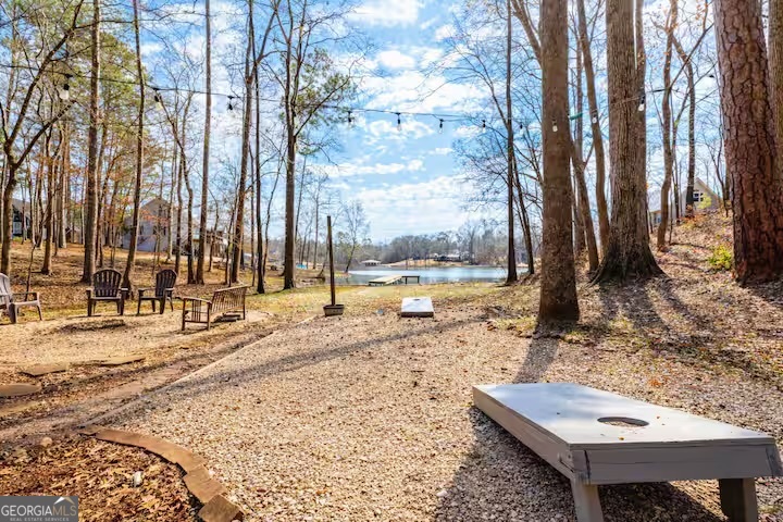 68 Franklin Road Eatonton, GA 31024 - Photo 8 of 28 a view of a backyard with large trees and wooden fence