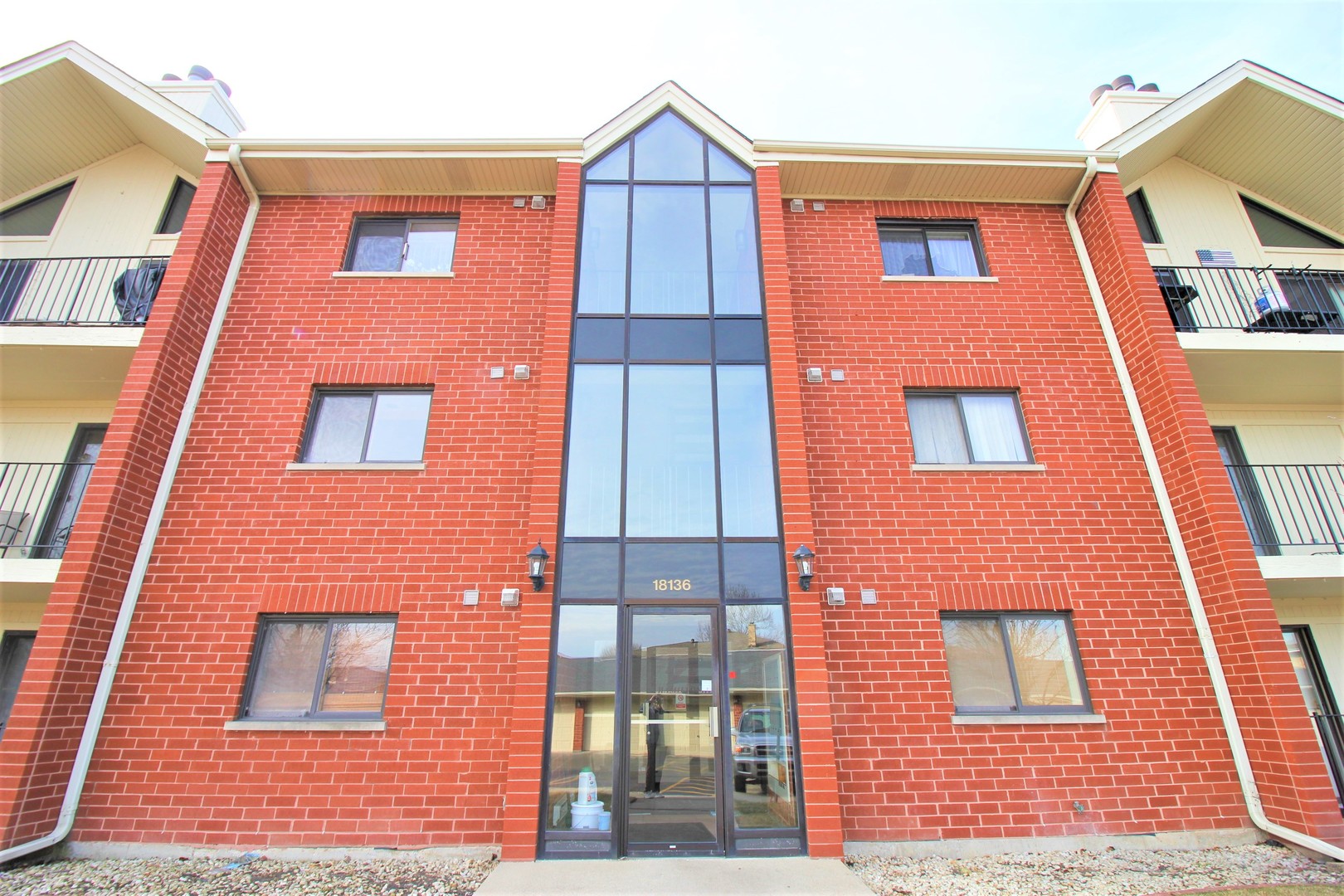18136 Rita Road, Unit 1A Tinley Park, IL 60477 - Photo 2 of 19 a building view with a brick wall
