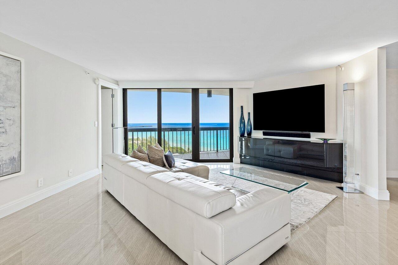 4545 North Ocean Boulevard, Unit 18D Boca Raton, FL 33431 - Photo 3 of 28 a living room with furniture and a flat screen tv