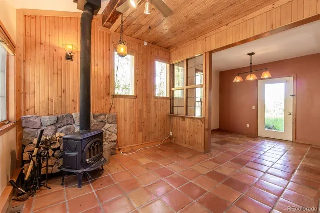 a living room with furniture and floor to ceiling windows