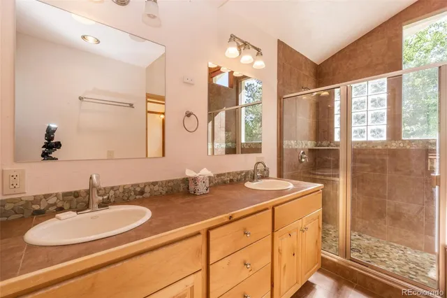 a bathroom with a sink double vanity and a mirror