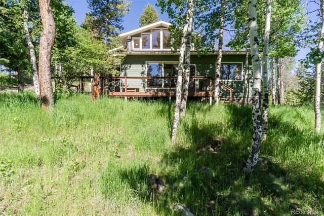 a view of a chairs and table in a backyard of the house