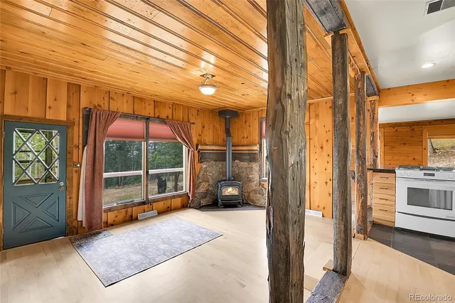 a view of a porch with furniture and floor to ceiling window
