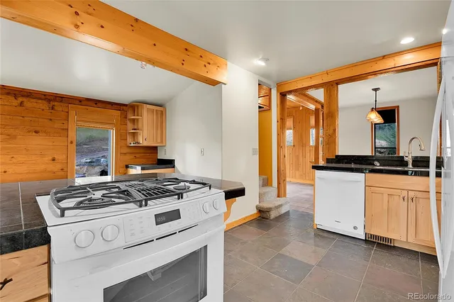 a kitchen with stainless steel appliances a stove a sink and a refrigerator