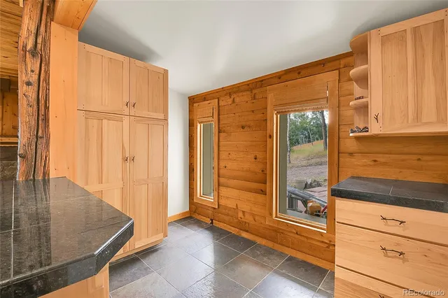 a view of a kitchen with wooden floor and a cabinet
