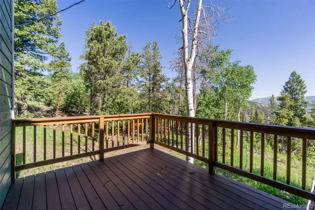 a view of balcony with wooden floor and fence