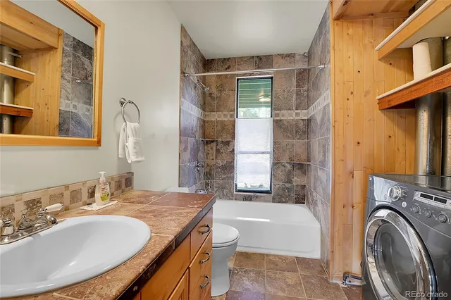 a spacious bathroom with a granite countertop sink and a mirror