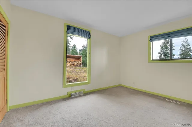 a view of an empty room with a closet