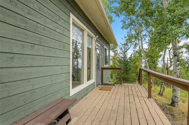 a view of a house with a yard and large tree