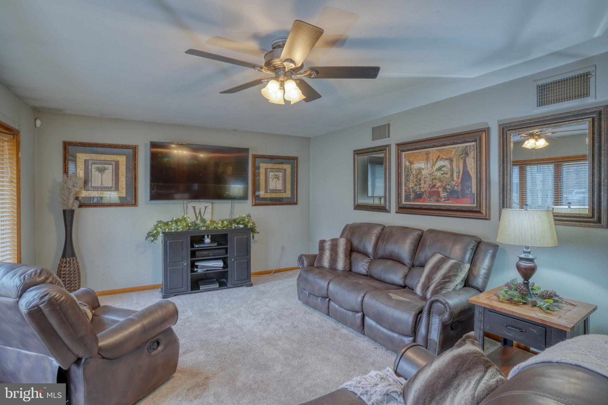 31674 Hickory Manor Road Frankford, DE 19945 - Photo 13 of 53 a living room with furniture and a flat screen tv
