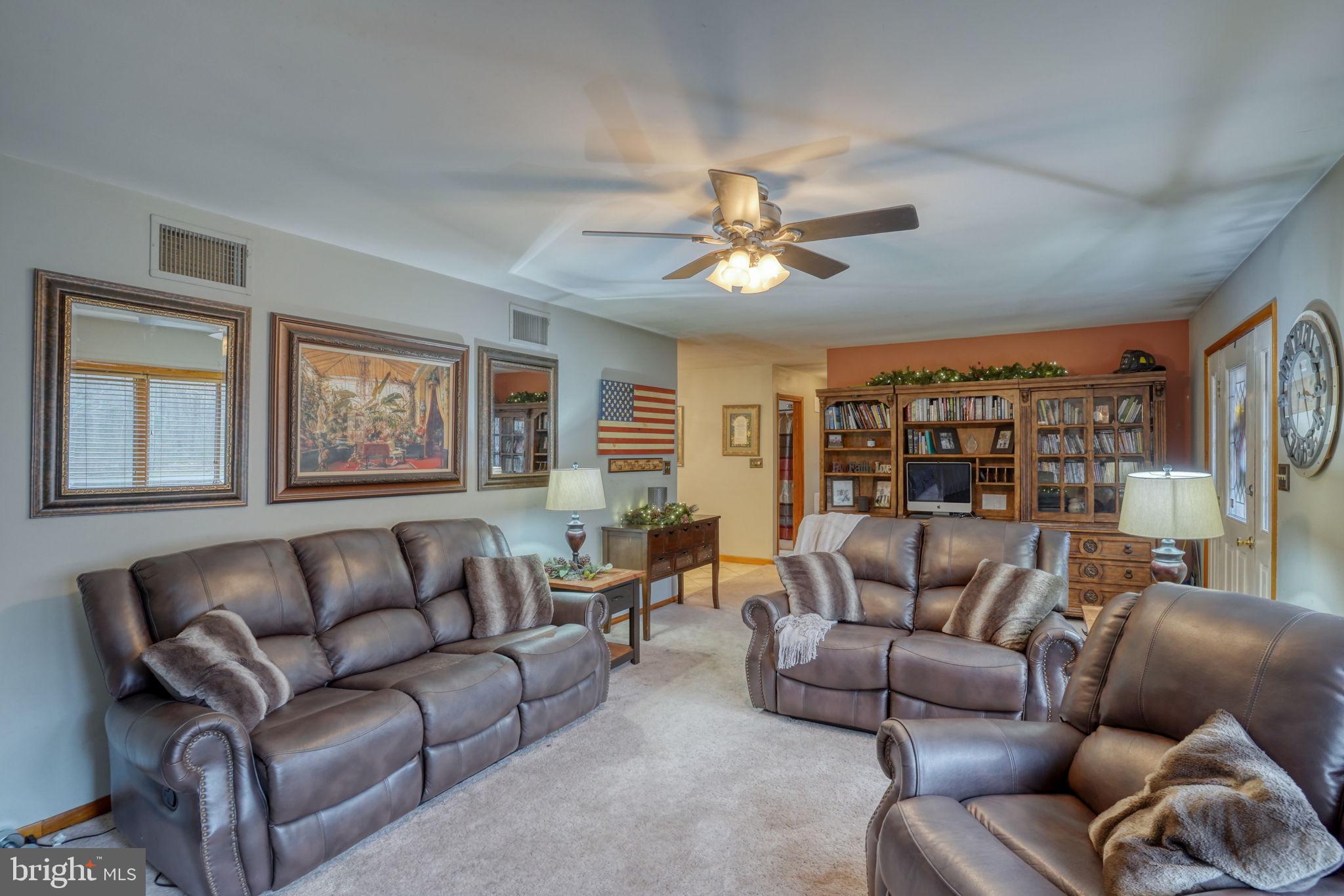 31674 Hickory Manor Road Frankford, DE 19945 - Photo 16 of 53 a living room with furniture ceiling fan and a window