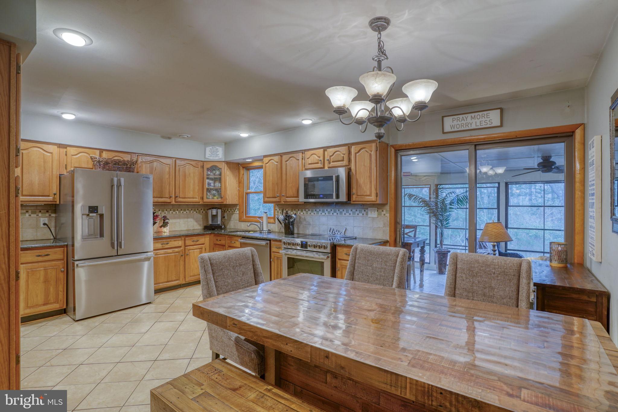31674 Hickory Manor Road Frankford, DE 19945 - Photo 17 of 53 a kitchen with stainless steel appliances granite countertop a stove refrigerator and cabinets