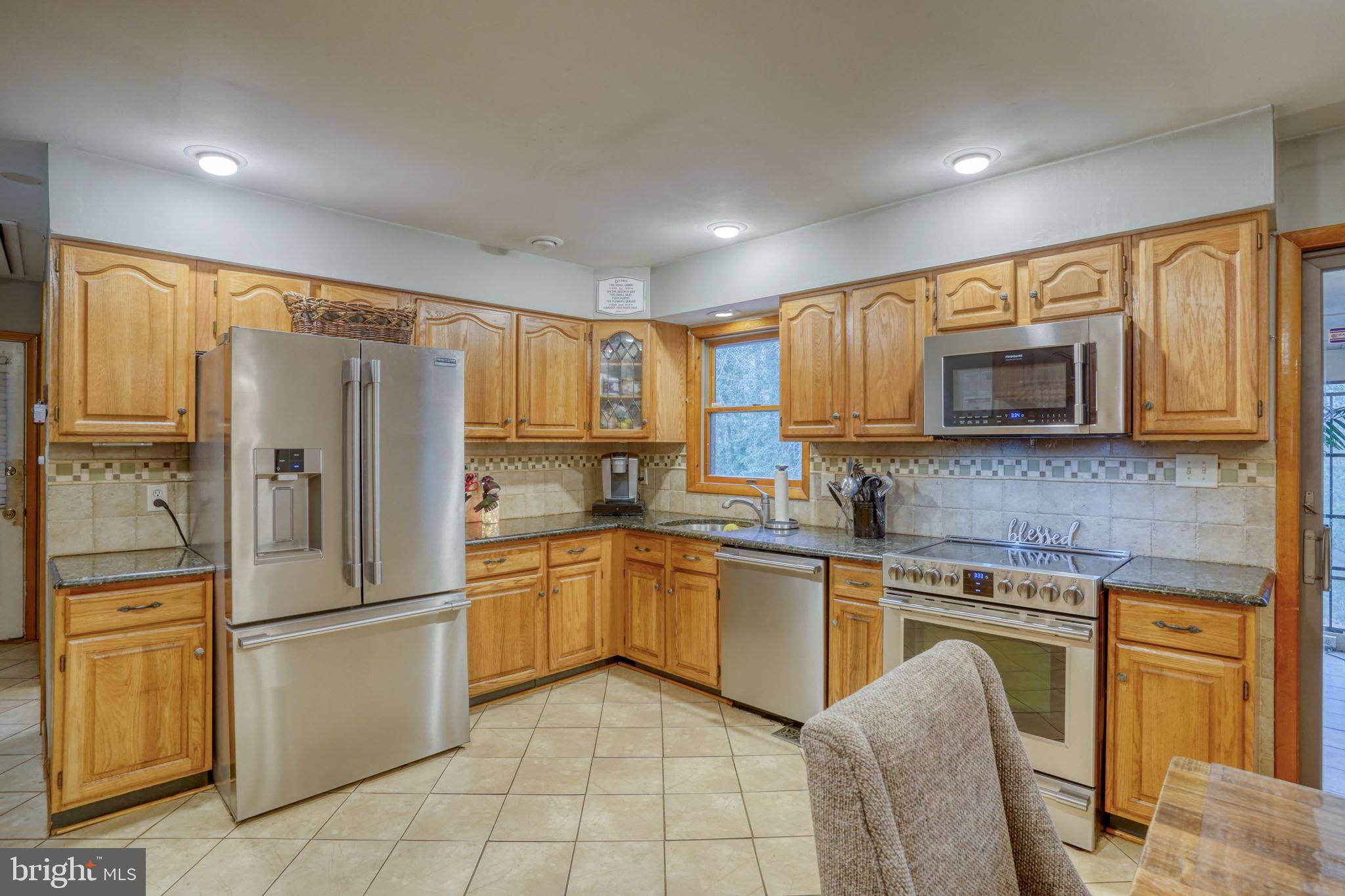 31674 Hickory Manor Road Frankford, DE 19945 - Photo 19 of 53 a kitchen with stainless steel appliances granite countertop a refrigerator and microwave