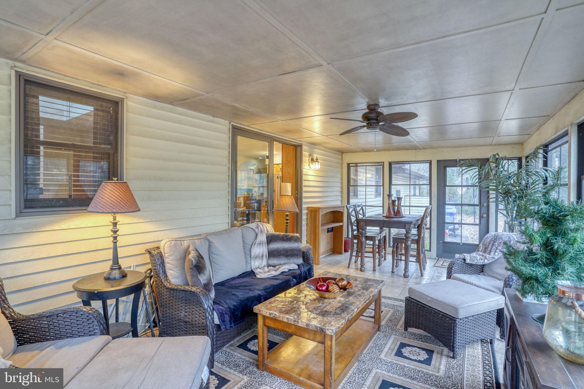 31674 Hickory Manor Road Frankford, DE 19945 - Photo 26 of 53 a living room with furniture a table and a large window