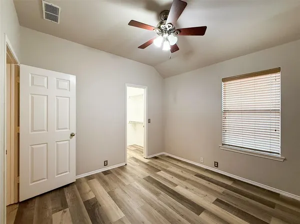 a view of a livingroom with a ceiling fan and window