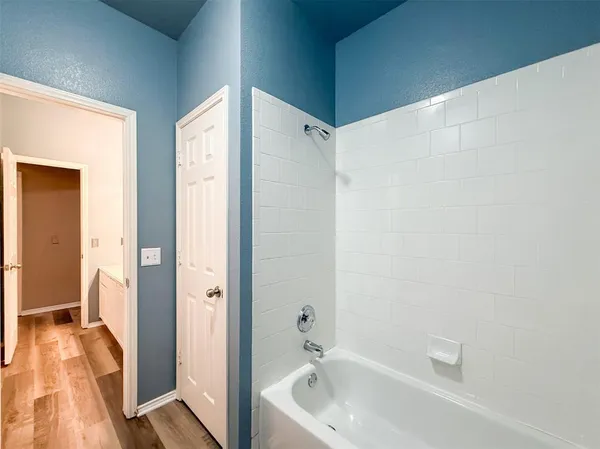 a bathroom with a tub and shower