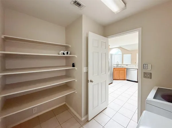 a view of kitchen with furniture and refrigerator