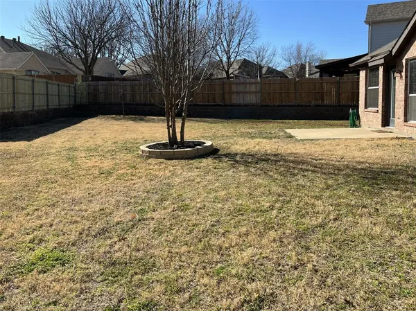 a view of a fountain in the backyard of house