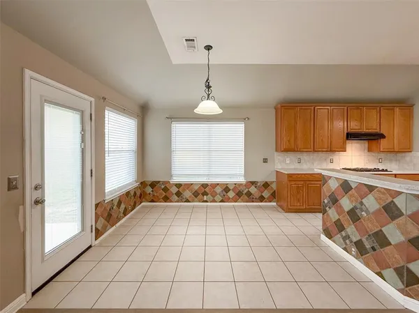 a large kitchen with granite countertop a stove a sink and a granite counter tops