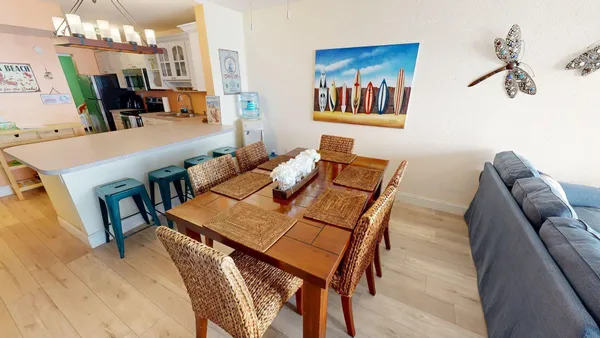 a view of a dining room with furniture and wooden floor