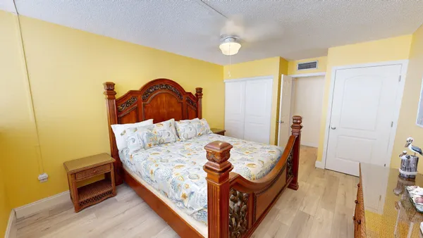 a bed sitting in a bedroom next to a window