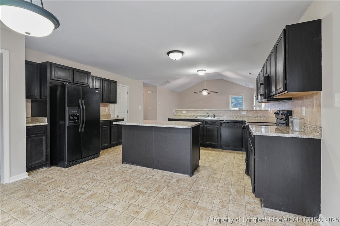 720 Cape Fear Road Raeford, NC 28376 - Photo 12 of 35 a kitchen with stainless steel appliances granite countertop a refrigerator and a sink