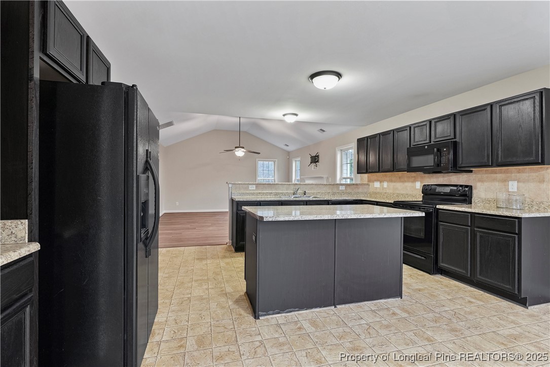 720 Cape Fear Road Raeford, NC 28376 - Photo 13 of 35 a kitchen with stainless steel appliances granite countertop a refrigerator and a stove top oven