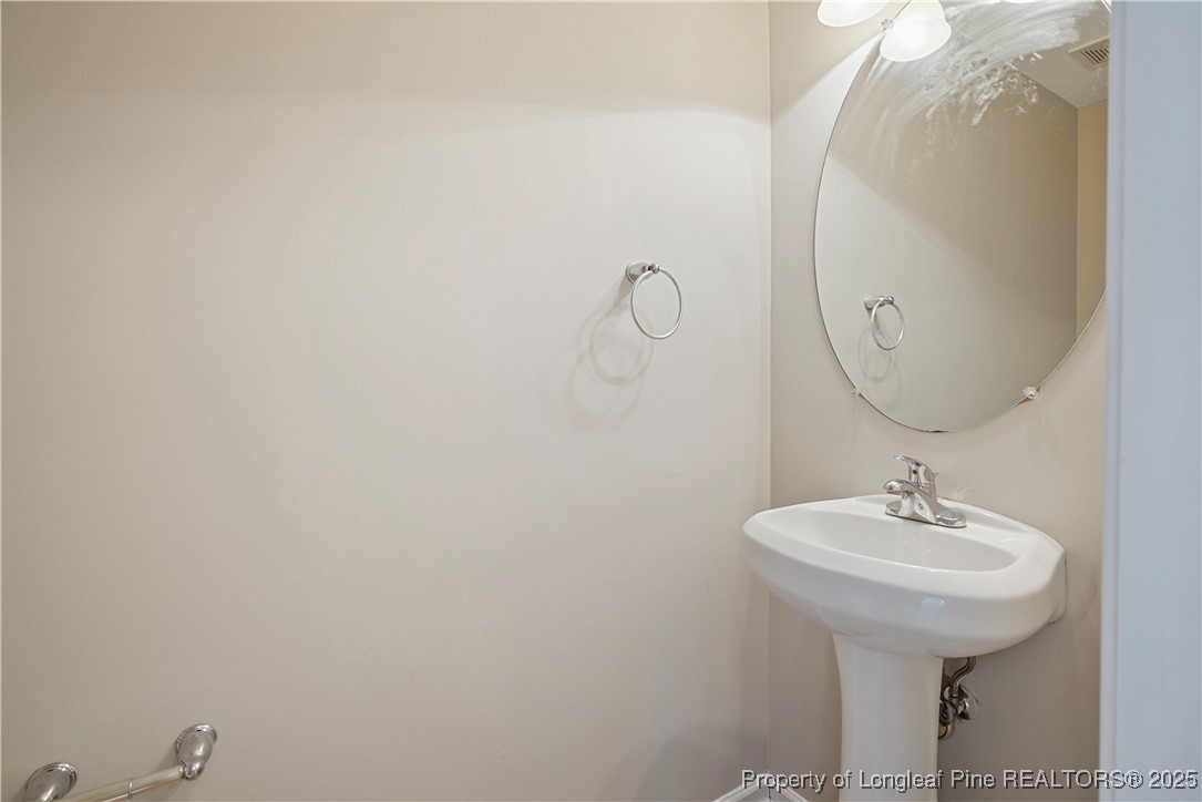 720 Cape Fear Road Raeford, NC 28376 - Photo 15 of 35 a bathroom with a sink and mirror