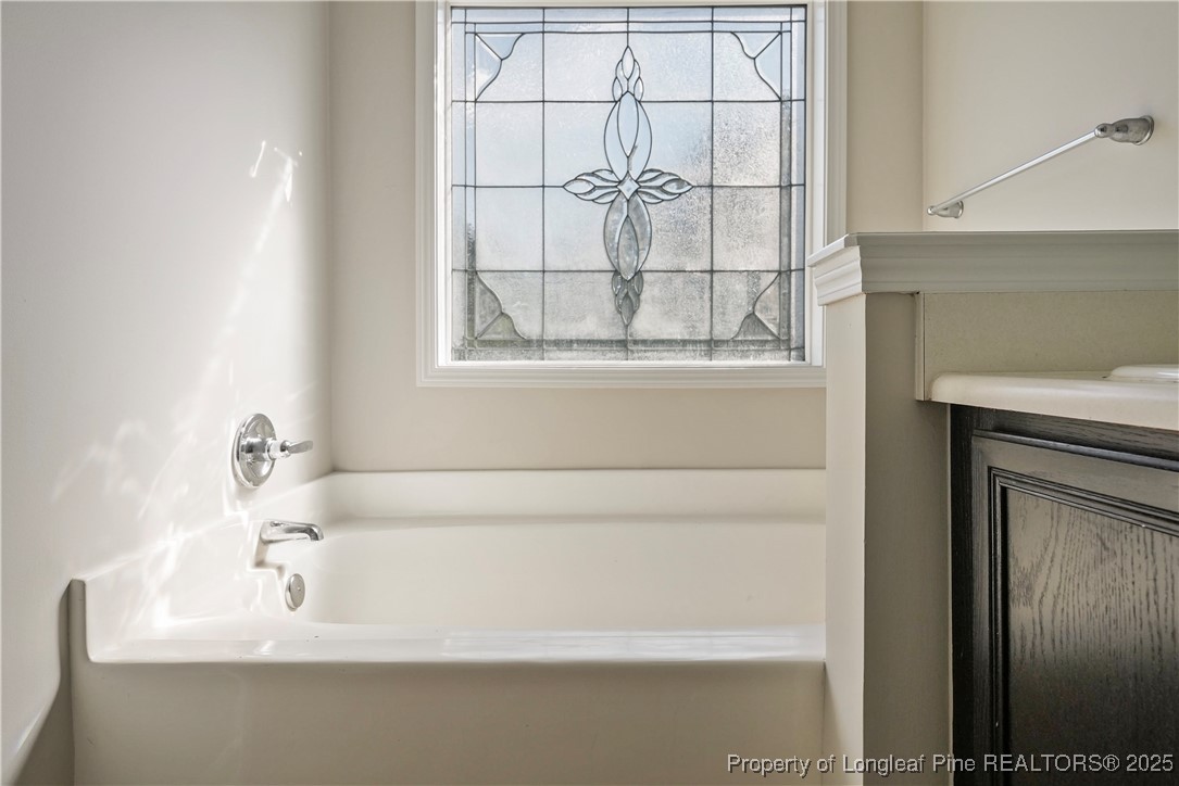 720 Cape Fear Road Raeford, NC 28376 - Photo 24 of 35 a bathroom with a bathtub and next to a window