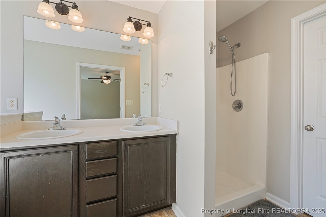 720 Cape Fear Road Raeford, NC 28376 - Photo 27 of 35 a bathroom with a double vanity sink mirror and shower