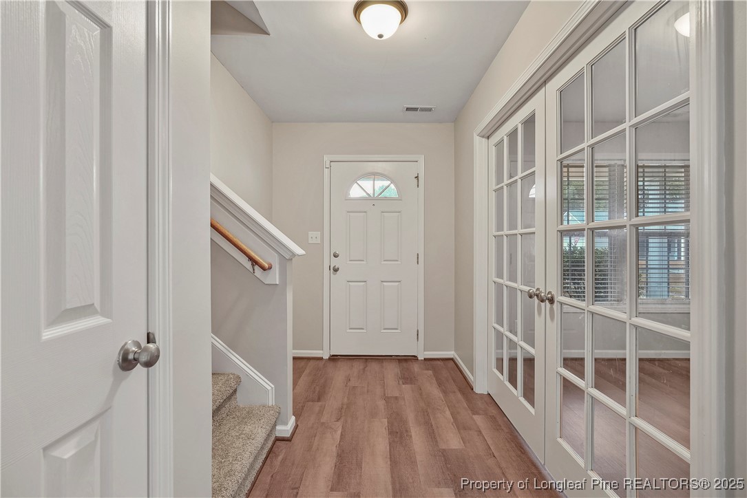 720 Cape Fear Road Raeford, NC 28376 - Photo 4 of 35 a view of a hallway with wooden floor and staircase
