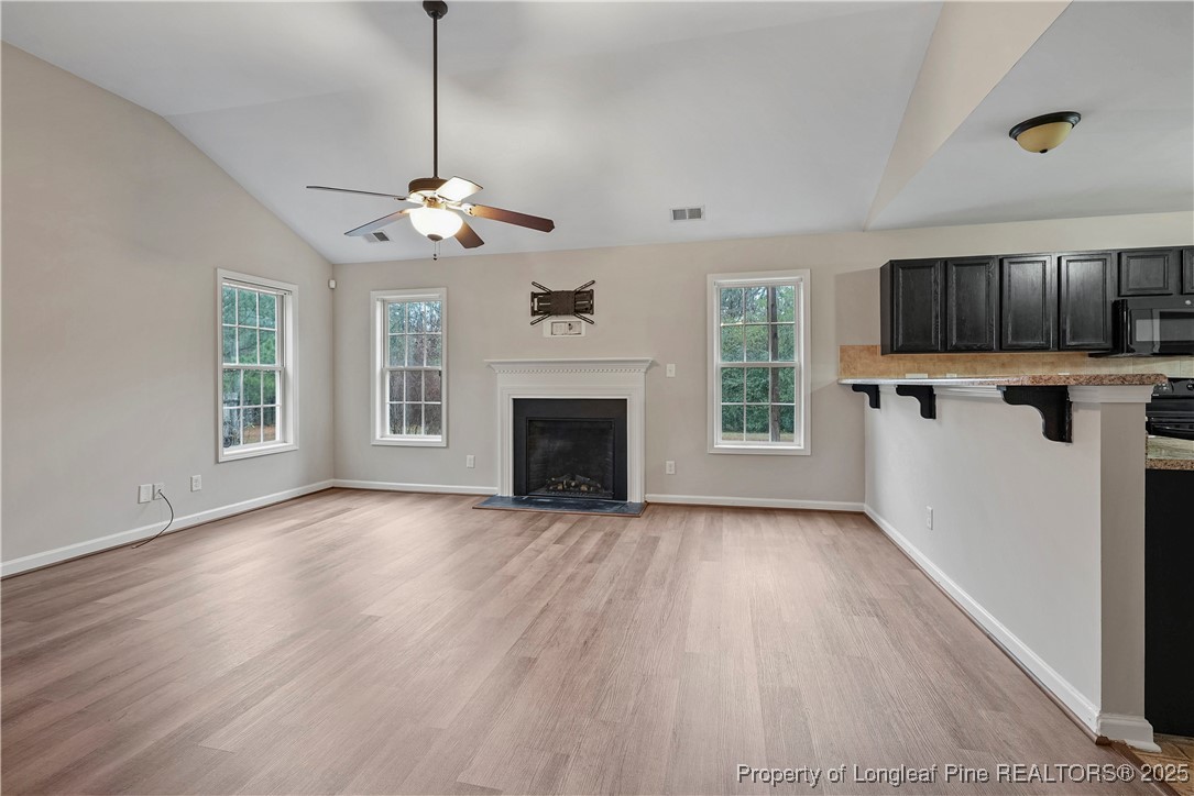 720 Cape Fear Road Raeford, NC 28376 - Photo 7 of 35 a view of an empty room with kitchen fireplace and a window