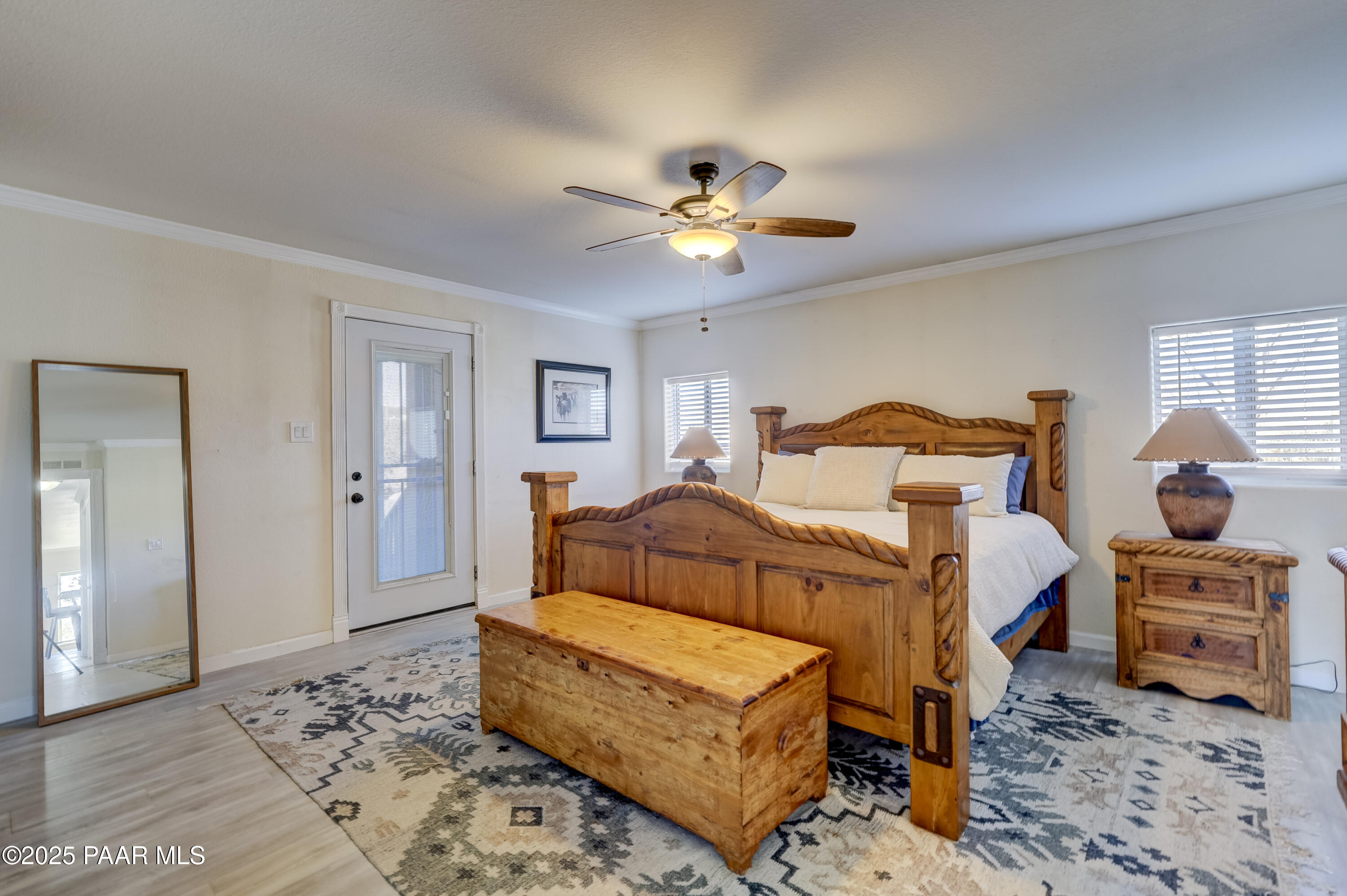 760 Yarber Wash Road Dewey, AZ 86327 - Photo 13 of 66 a bedroom with a bed and wooden floor