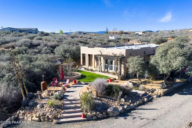 an aerial view of a house with a yard basket ball court and outdoor seating
